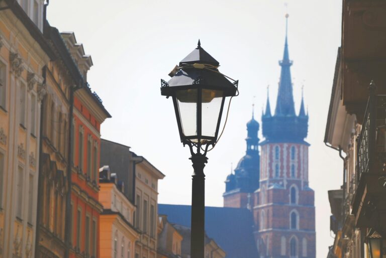 Street view featuring St. Mary's Basilica and a historic lamp post in Kraków, Poland.
